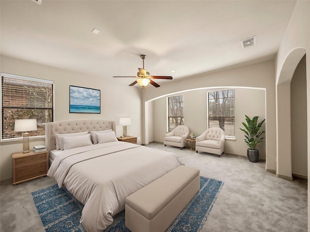 bedroom featuring a ceiling fan, light colored carpet, and visible vents