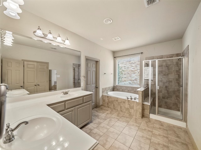 bathroom featuring a garden tub, a sink, visible vents, a shower stall, and double vanity