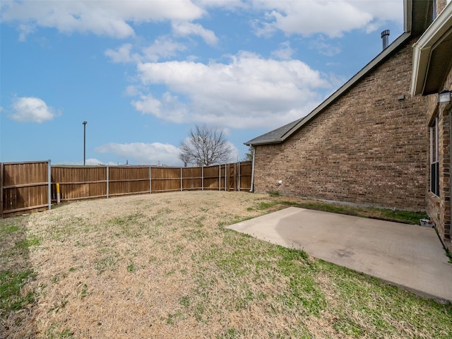 view of yard with a fenced backyard and a patio