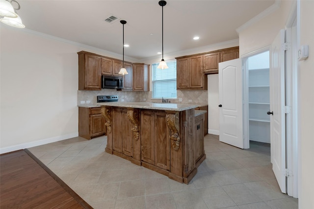 kitchen with visible vents, ornamental molding, backsplash, brown cabinets, and stainless steel microwave