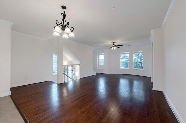 unfurnished living room featuring baseboards, ceiling fan with notable chandelier, dark wood finished floors, and crown molding