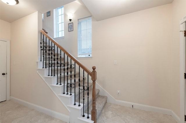 staircase featuring baseboards