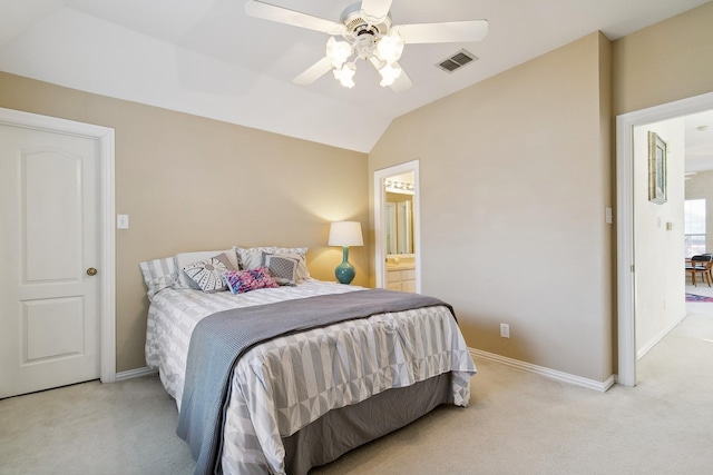 carpeted bedroom with baseboards, visible vents, ensuite bath, ceiling fan, and vaulted ceiling