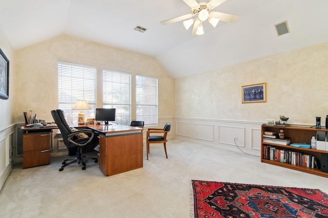 office area featuring wainscoting, light carpet, vaulted ceiling, and visible vents