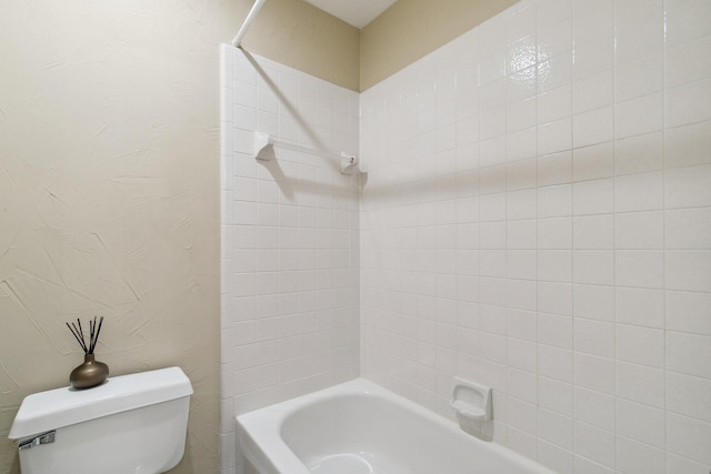 full bath featuring a textured wall, shower / bath combination, and toilet