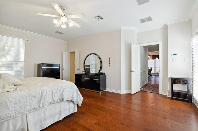 bedroom with visible vents, baseboards, and wood finished floors