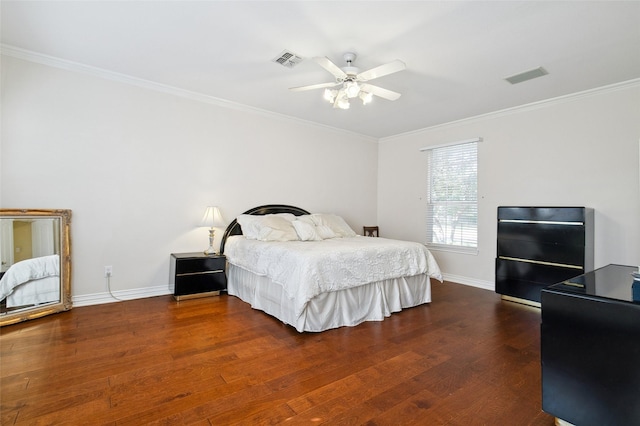 bedroom with ornamental molding, wood finished floors, and visible vents