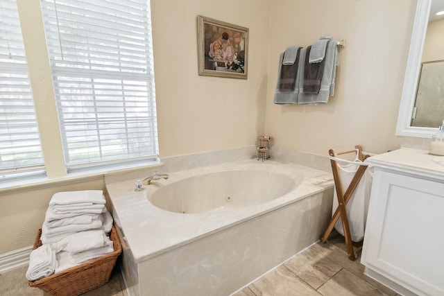 full bath with a tub with jets and vanity