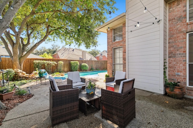 view of patio featuring outdoor lounge area, a fenced backyard, and a fenced in pool