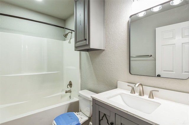 full bath featuring shower / washtub combination, a textured wall, vanity, and toilet