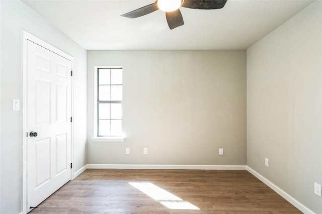 spare room with ceiling fan, baseboards, and wood finished floors