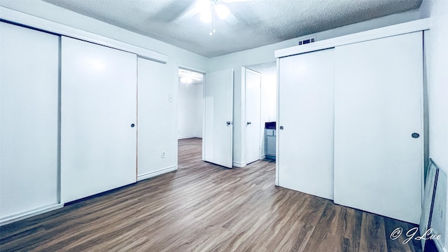 unfurnished bedroom featuring visible vents, ceiling fan, a textured ceiling, and wood finished floors