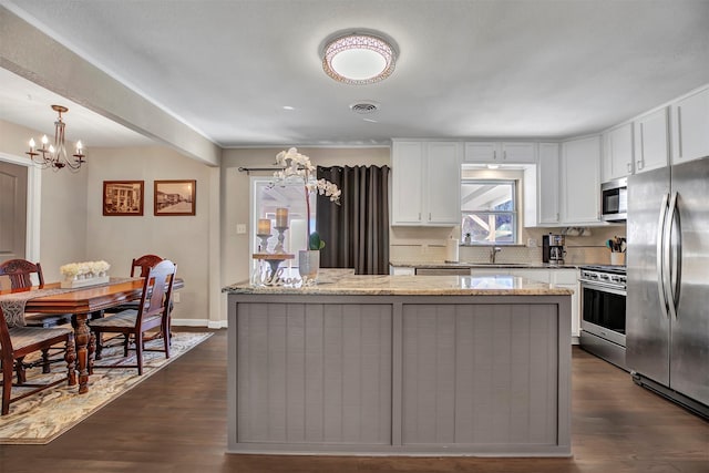 kitchen featuring appliances with stainless steel finishes, dark wood-type flooring, visible vents, and white cabinets