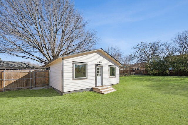 view of outdoor structure featuring an outbuilding and a fenced backyard