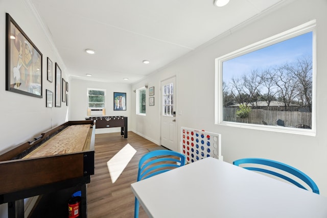 recreation room with baseboards, crown molding, wood finished floors, and recessed lighting