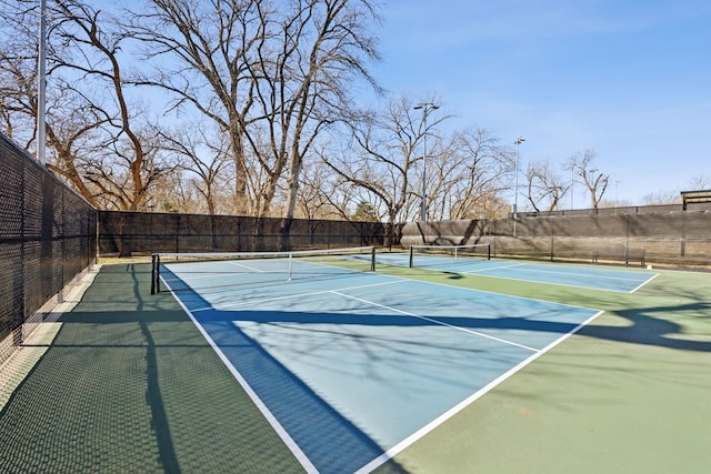 view of sport court featuring fence