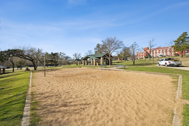 view of home's community featuring a yard and volleyball court