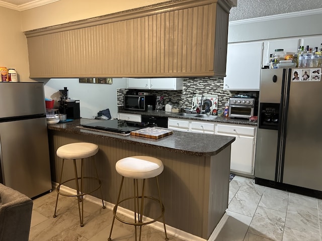 kitchen featuring black appliances, a peninsula, a sink, and crown molding