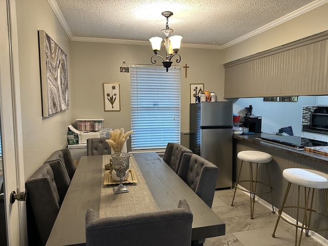 dining area with marble finish floor, a textured ceiling, ornamental molding, and a notable chandelier