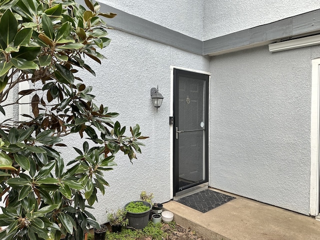 doorway to property with stucco siding