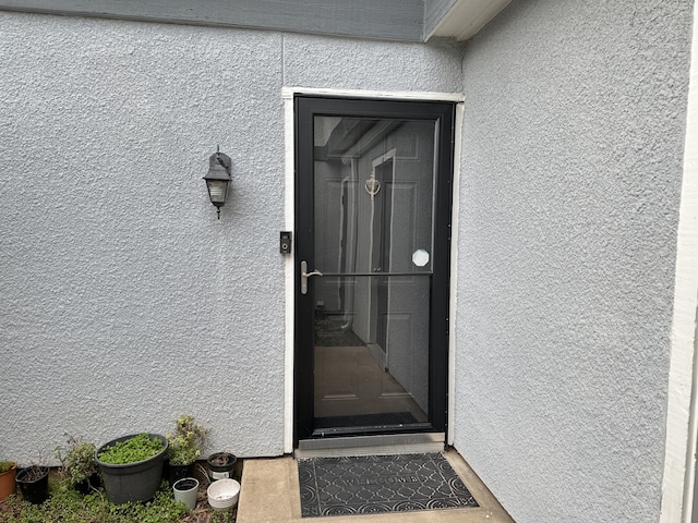 property entrance with stucco siding