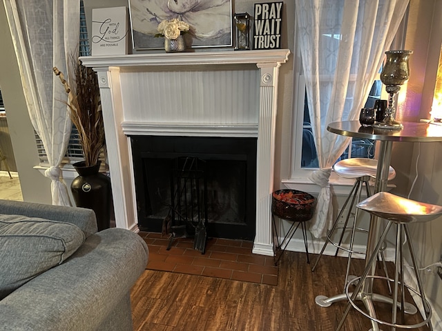 details featuring wood finished floors and a fireplace with flush hearth