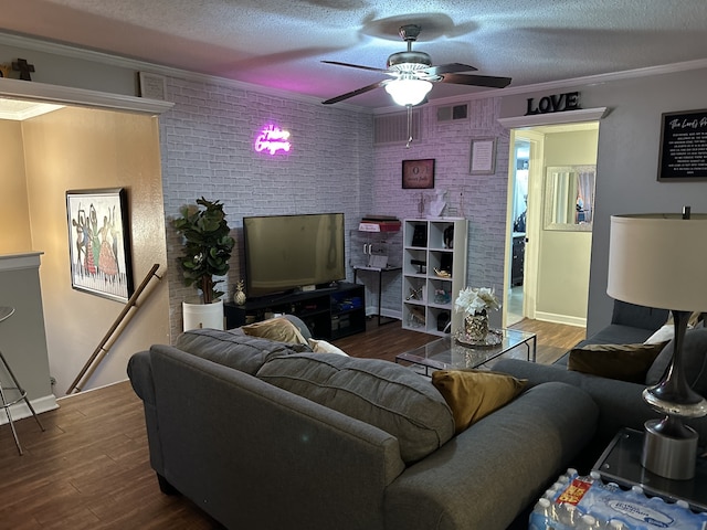 living room featuring a ceiling fan, crown molding, a textured ceiling, and wood finished floors