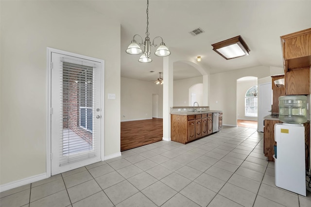 kitchen with light tile patterned floors, light countertops, visible vents, a sink, and dishwasher