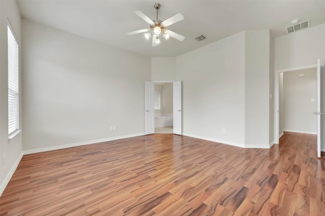 unfurnished room featuring a ceiling fan, light wood-type flooring, and visible vents