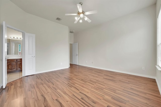 unfurnished room with a ceiling fan, light wood-style flooring, visible vents, and baseboards