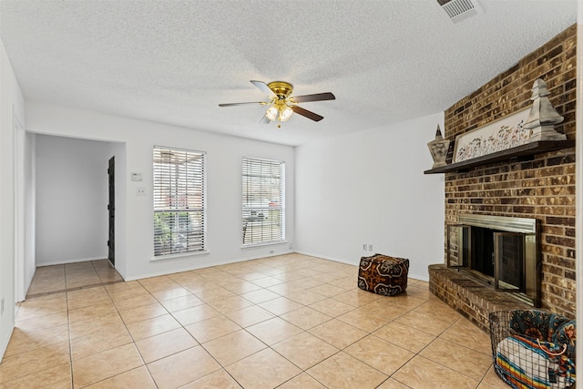 living room featuring visible vents, a textured ceiling, light tile patterned floors, a brick fireplace, and ceiling fan