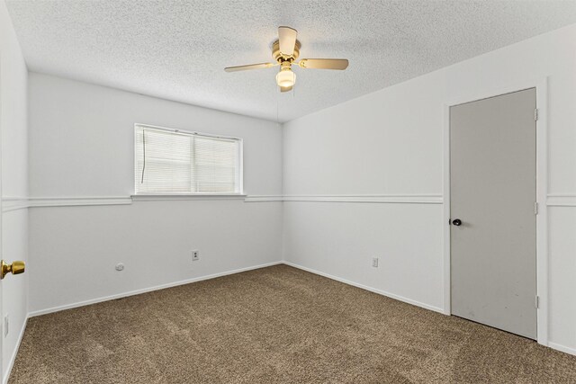 unfurnished room with ceiling fan, carpet, baseboards, and a textured ceiling