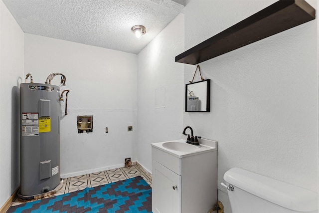 bathroom featuring vanity, baseboards, a textured ceiling, toilet, and electric water heater