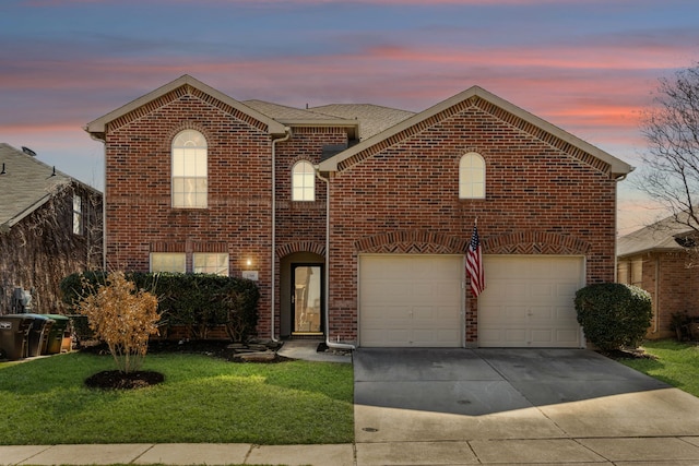 traditional-style house with a garage, concrete driveway, a front lawn, and brick siding