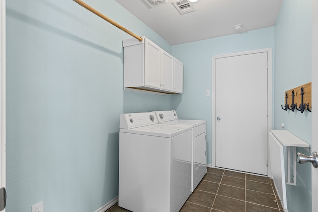 washroom with cabinet space, visible vents, independent washer and dryer, and dark tile patterned flooring