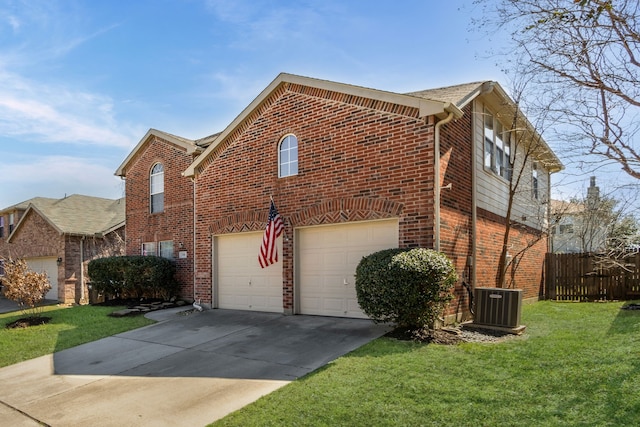 view of side of home featuring central air condition unit, brick siding, fence, concrete driveway, and a lawn