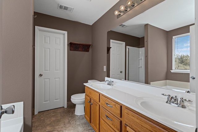 full bathroom featuring visible vents, a sink, and a shower stall