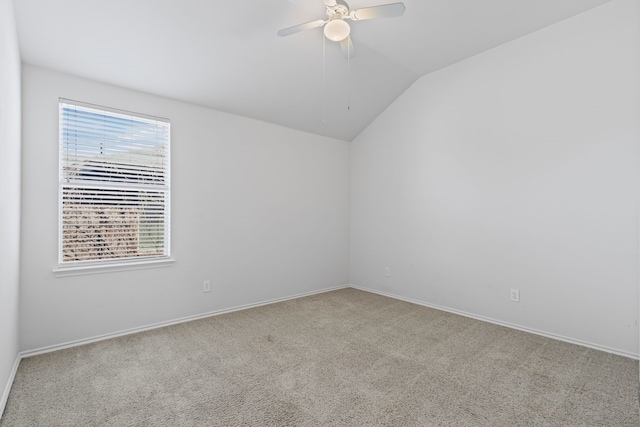 unfurnished room featuring lofted ceiling, carpet flooring, ceiling fan, and baseboards