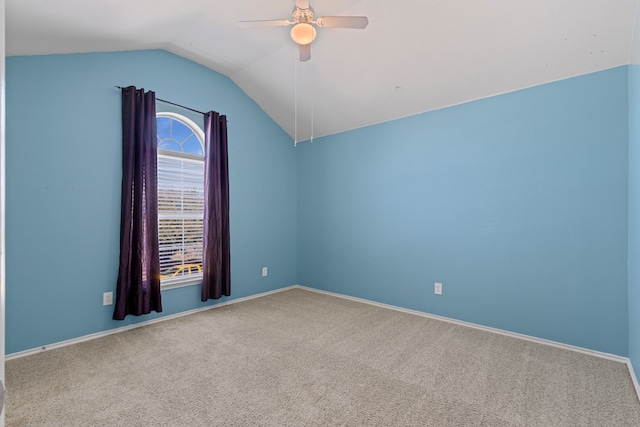 unfurnished room with lofted ceiling, baseboards, carpet floors, and a ceiling fan