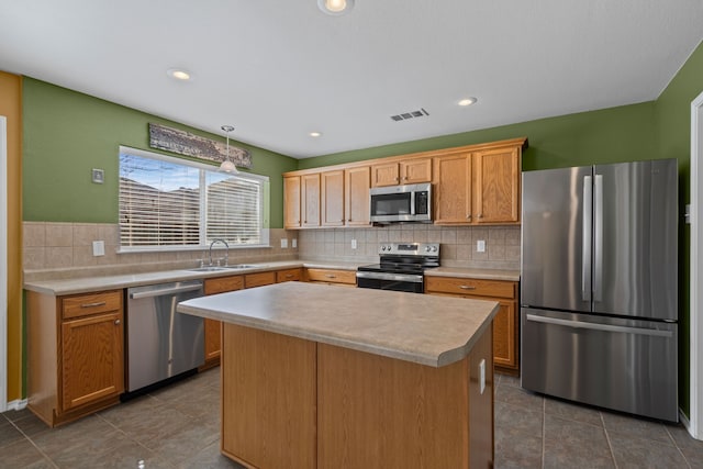 kitchen featuring decorative backsplash, stainless steel appliances, a sink, and light countertops