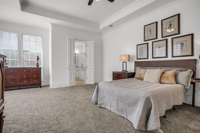 bedroom with a tray ceiling, carpet flooring, crown molding, and baseboards