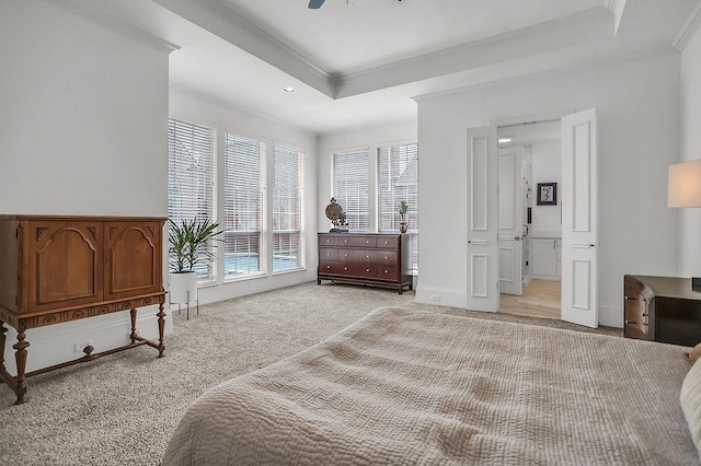 bedroom featuring a tray ceiling, light colored carpet, ornamental molding, ceiling fan, and baseboards