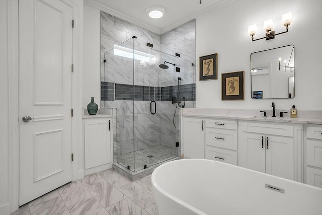 full bathroom featuring vanity, a freestanding bath, marble finish floor, a shower stall, and crown molding