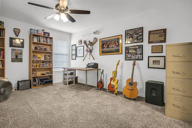 interior space featuring ceiling fan, carpet floors, and baseboards