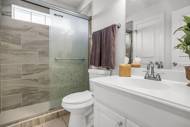 bathroom with a stall shower, tile patterned flooring, vanity, and toilet