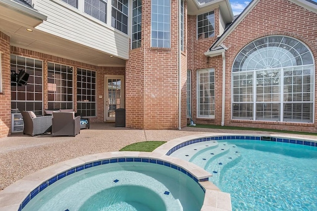 view of pool with a pool with connected hot tub and a patio