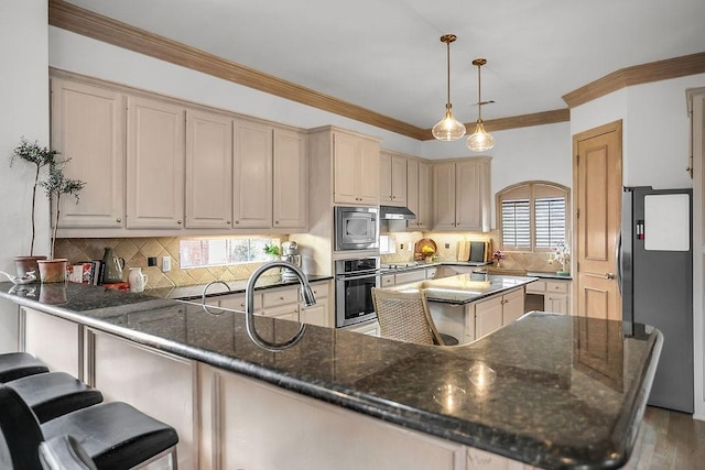 kitchen featuring decorative backsplash, appliances with stainless steel finishes, ornamental molding, a peninsula, and hanging light fixtures