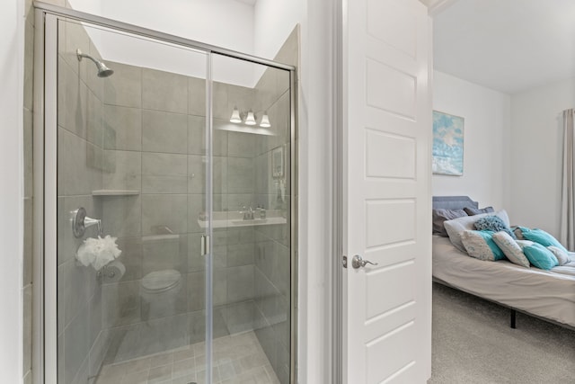 ensuite bathroom featuring ensuite bath and a shower stall