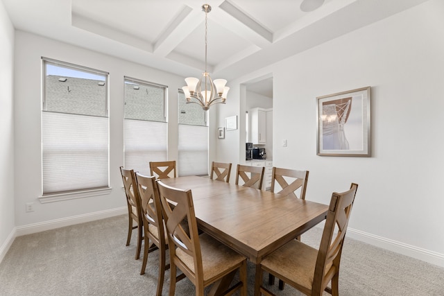 dining room with beamed ceiling, a notable chandelier, coffered ceiling, and light colored carpet