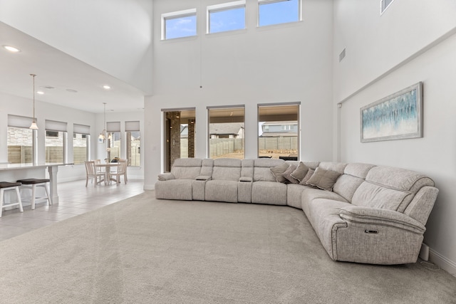 tiled living room with baseboards, carpet flooring, visible vents, and recessed lighting